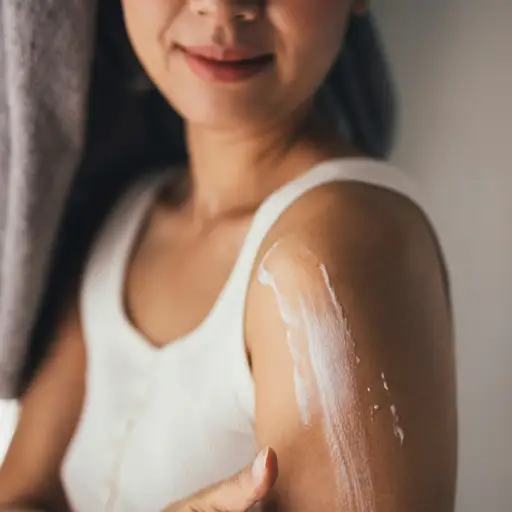 woman with lotion on arm